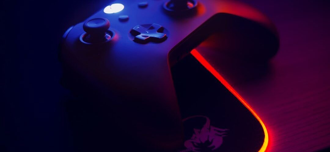 Gaming controller on an RGB mousepad with an illuminated edge