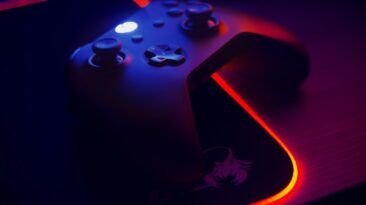 Gaming controller on an RGB mousepad with an illuminated edge