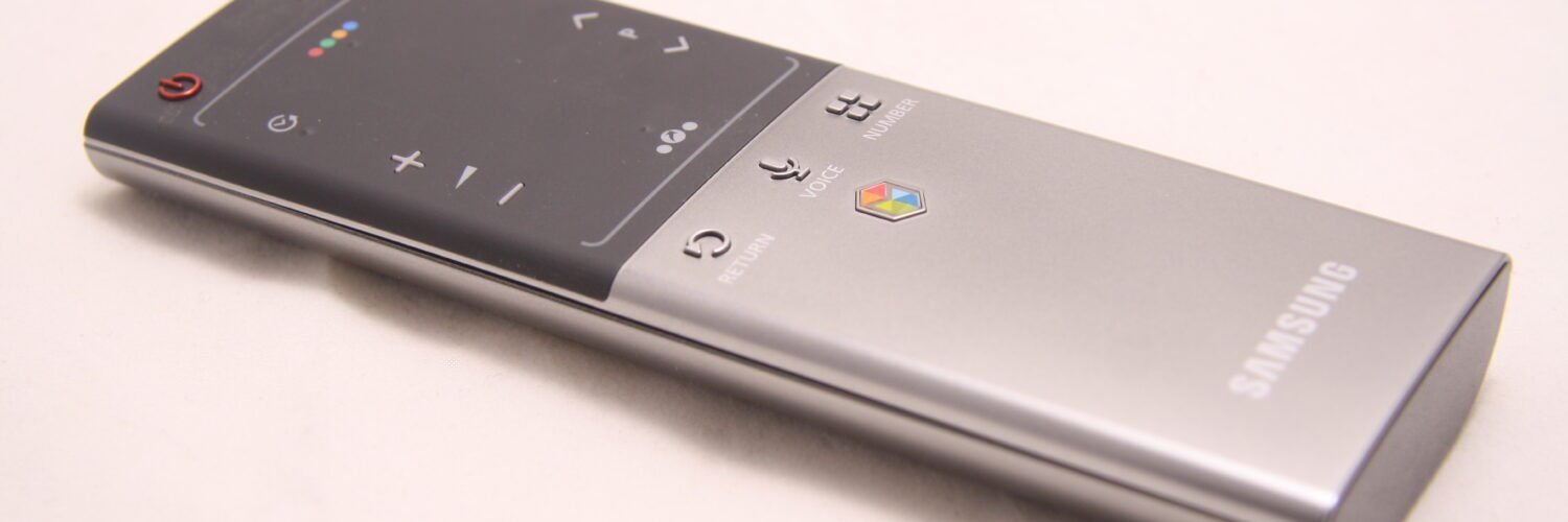 Samsung smart TV remote used to navigate streaming apps and enter an activation code.