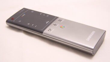 Samsung smart TV remote used to navigate streaming apps and enter an activation code.