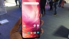 OnePlus 7 Pro smartphone photographed at its launch, illustrating a Qualcomm CrashDump troubleshooting guide.