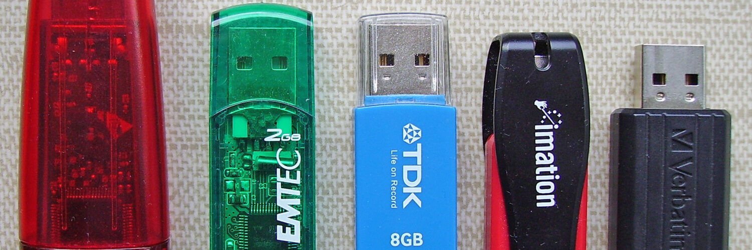 Five USB flash drives of different brands and capacities.