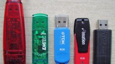 Five USB flash drives of different brands and capacities.