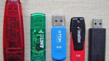 Five USB flash drives of different brands and capacities.